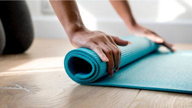 Hands on rolled up pilates mat. Pilates.